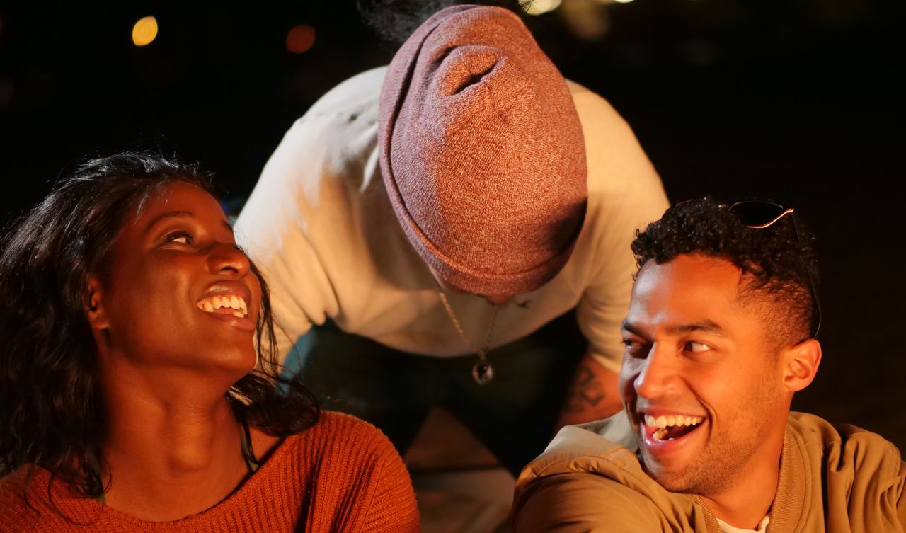 A group of friends enjoying an evening hangout, laughing and sharing joyful moments.